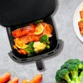 TESLA AirCook Q60 XXL Pro Fritteuse zur Zubereitung von gebackenem Lachs mit Zitrone und Gemüse, ideal für eine gesunde Ernährung.
